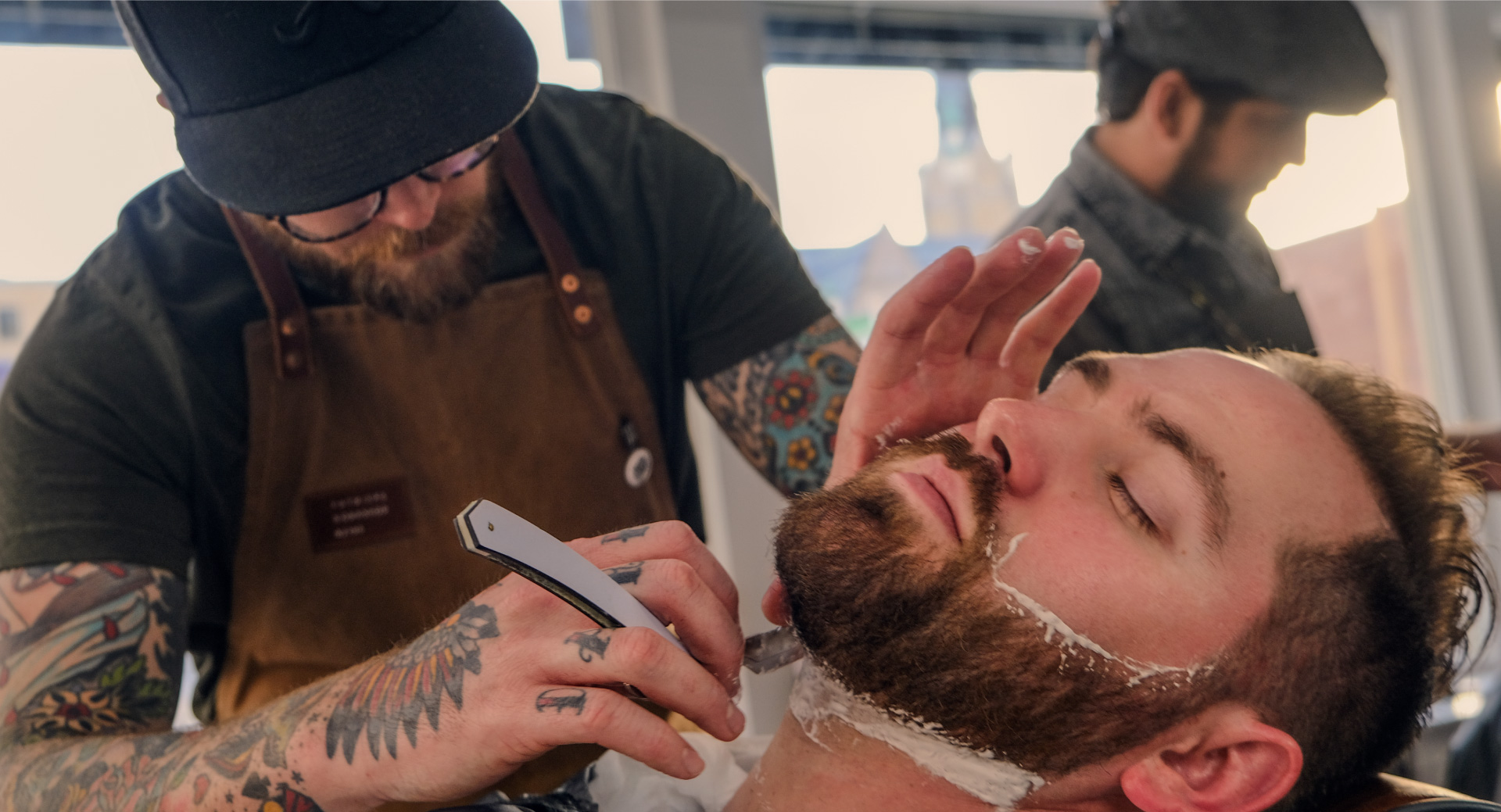 Photograph of Cody Mayes performing a straight razor shave